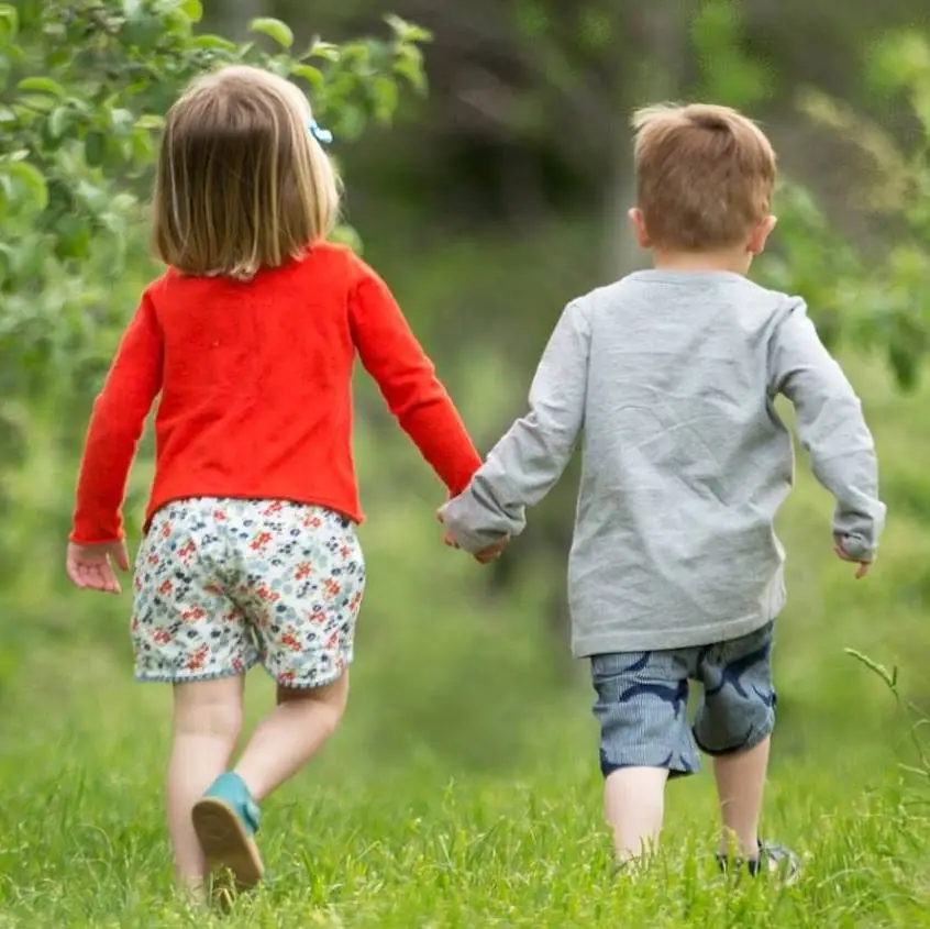 Boy and Girl Walking through field